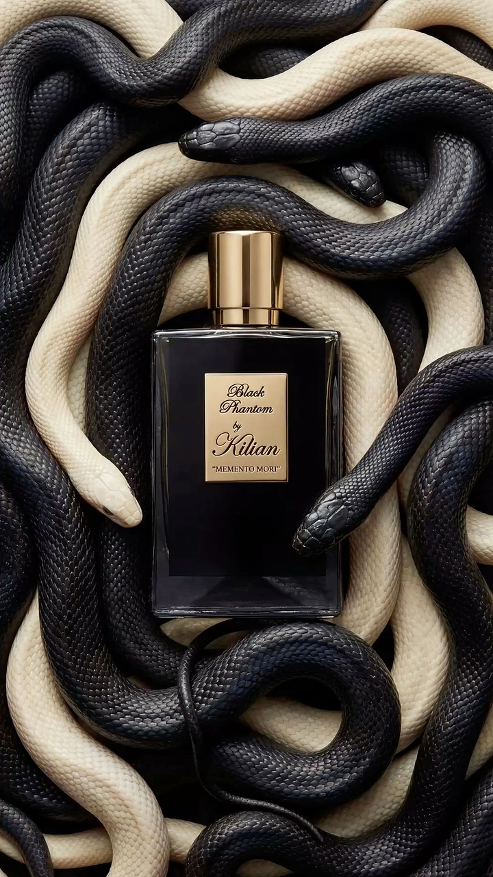 Halloween creative ad: Black perfume bottle nested among coiled snakes