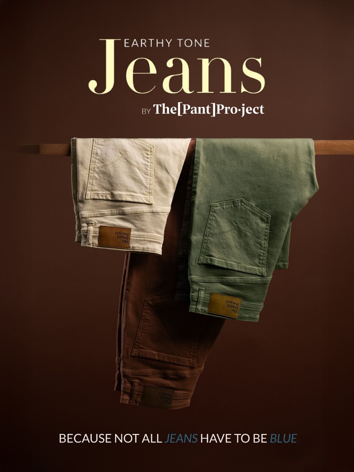 Instagram post: Three earthy-tone jeans draped over a wooden rail