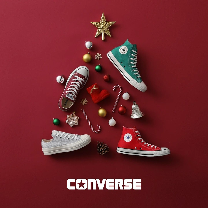 Christmas creative ad: Sneakers and ornaments arranged into a Christmas tree flat lay