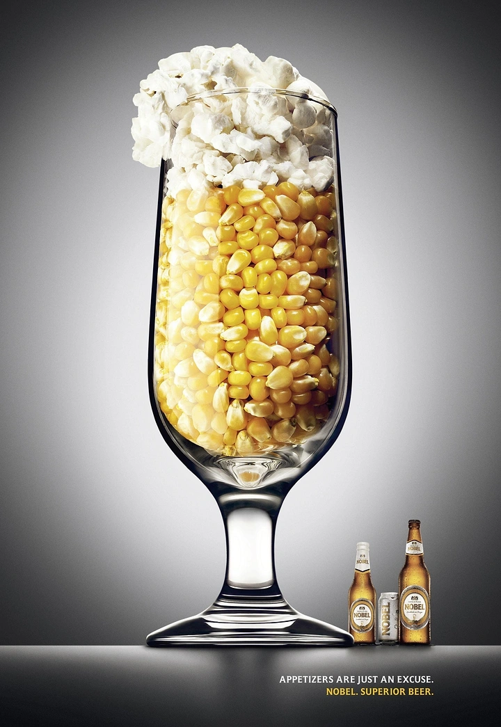 Beer, Wine & Spirits creative ad: A stemmed beer glass filled with corn kernels and topped with popcorn as foam