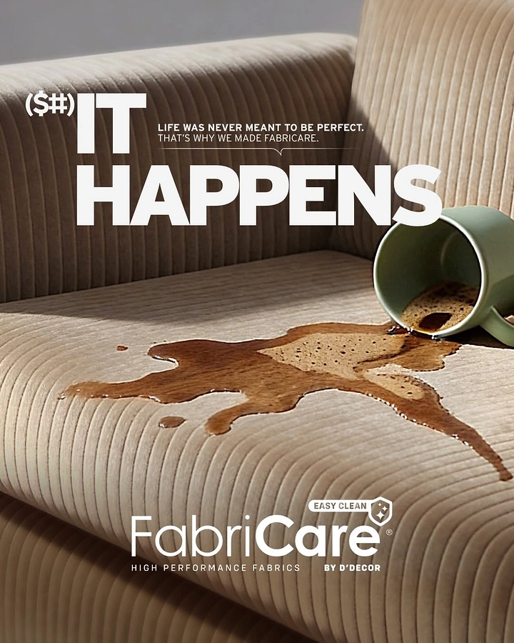 Creative ad: Coffee spilled from tipped mug beading on corduroy sofa