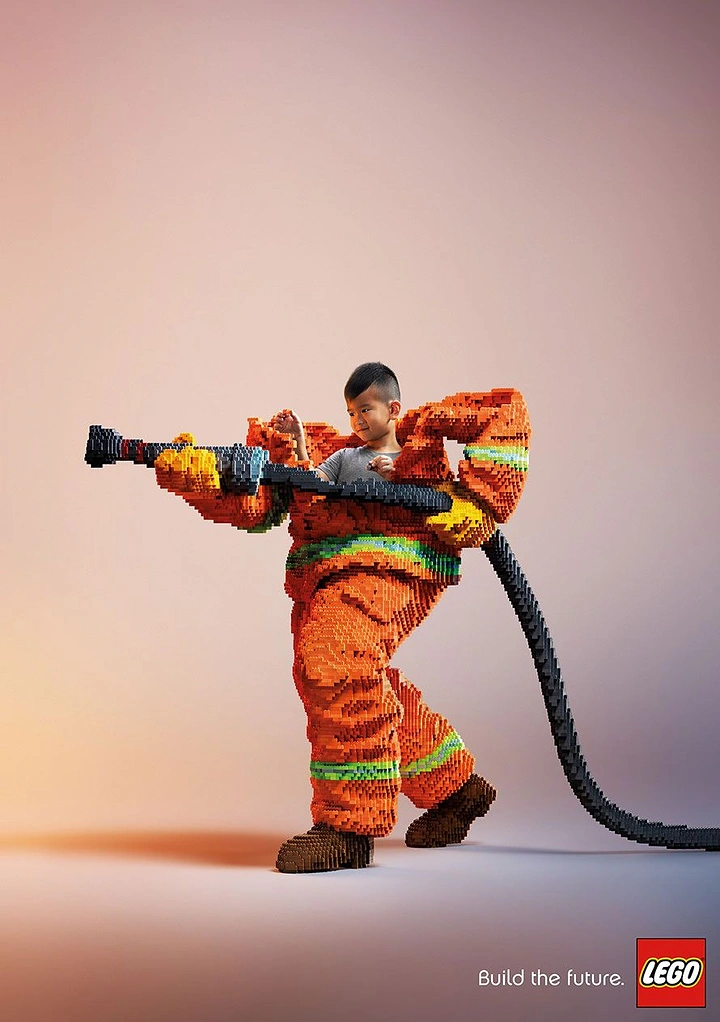 Toy Stores creative ad: Boy wearing an oversized firefighter suit built from toy bricks