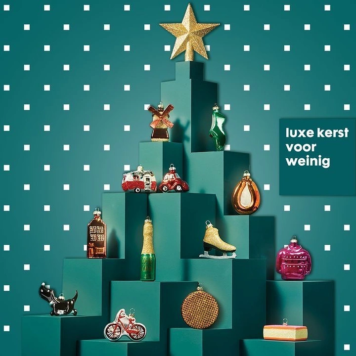 Christmas creative ad: Novelty glass ornaments on teal plinths stacked into a tree shape
