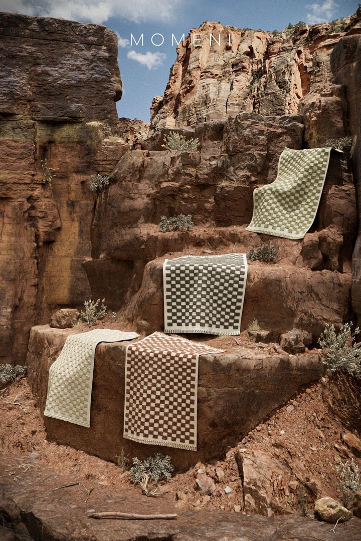 Rugs & Carpets creative ad: Rugs staged dramatically in canyon