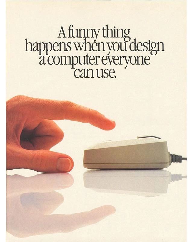 Electronics creative ad: Finger about to click a beige computer mouse