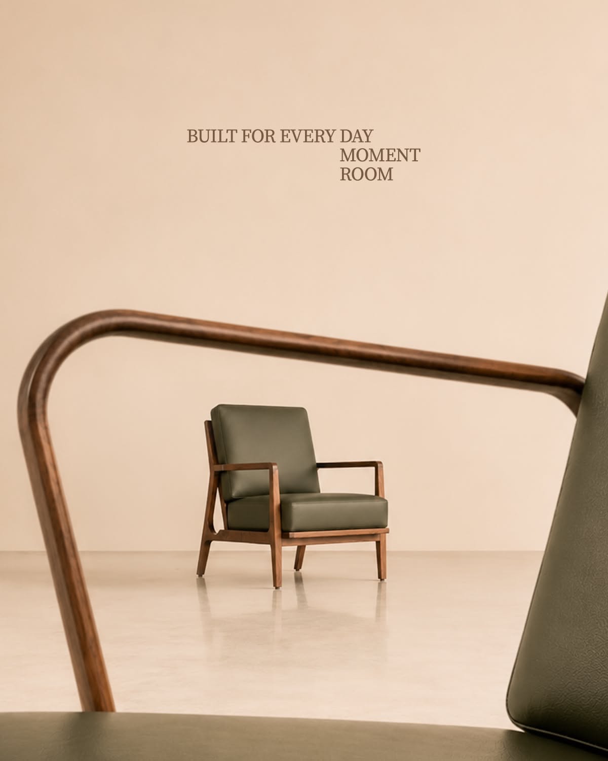 Instagram post: Olive leather lounge chair framed through a foreground chair's wooden armrest