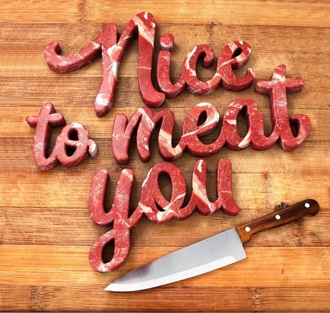 Instagram post: Script lettering sculpted from raw marbled meat on a cutting board