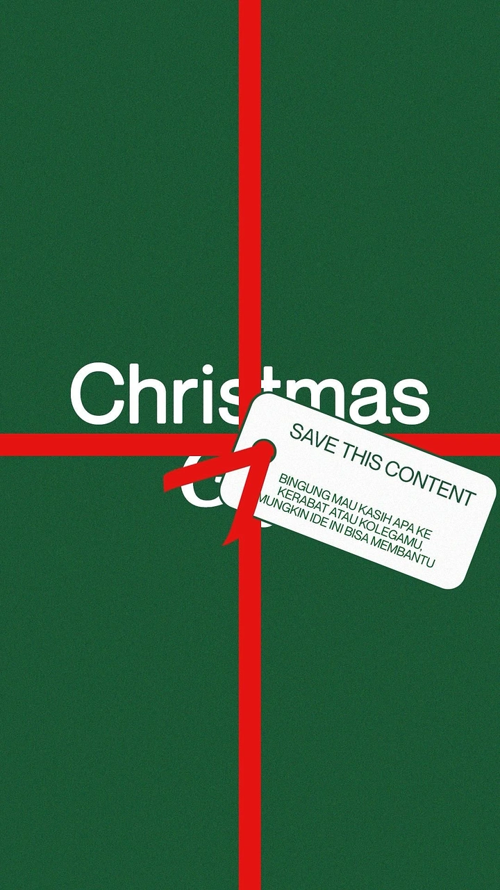 Christmas creative ad: Full-frame green gift wrap crossed by red ribbon with a paper tag