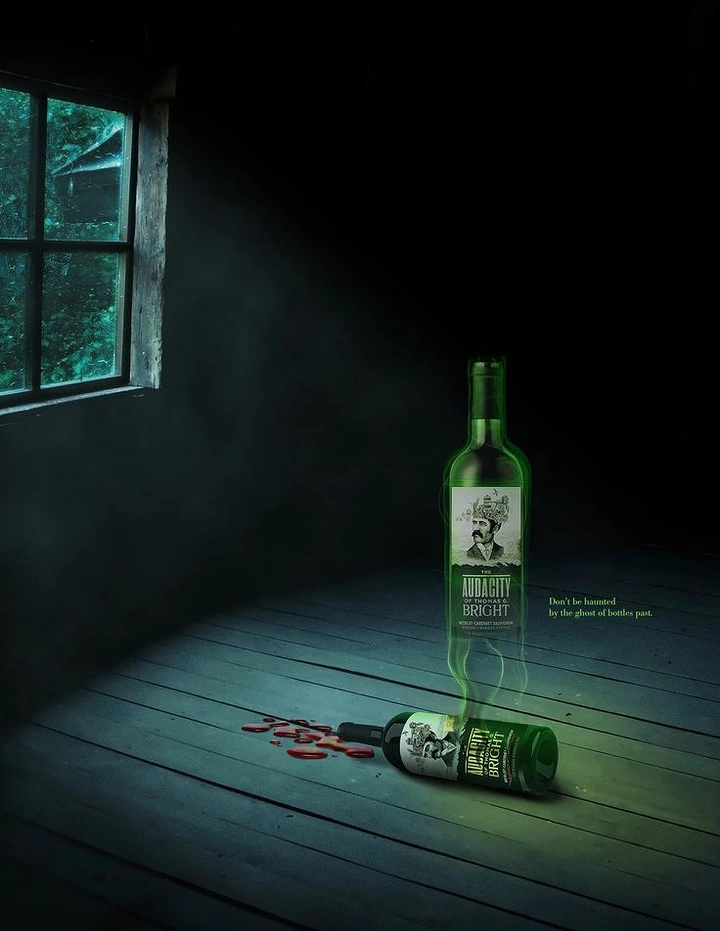 Halloween creative ad: Ghostly glowing wine bottle rising from a toppled bottle