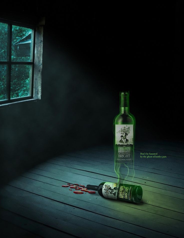 Ghostly glowing wine bottle rising from a toppled bottle