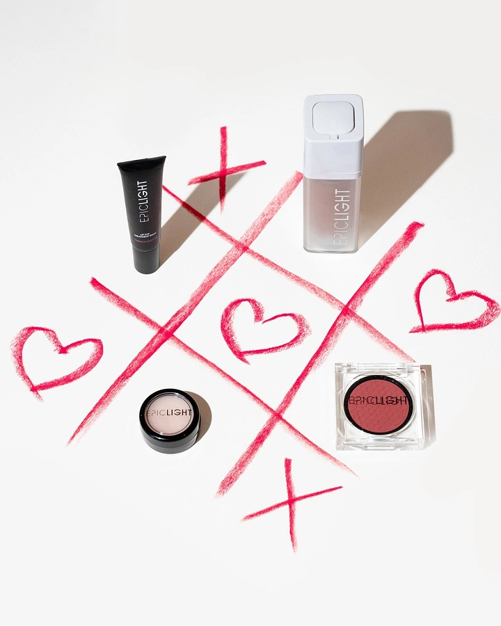 Valentine's Day creative ad: Makeup products on a lipstick-drawn tic-tac-toe grid