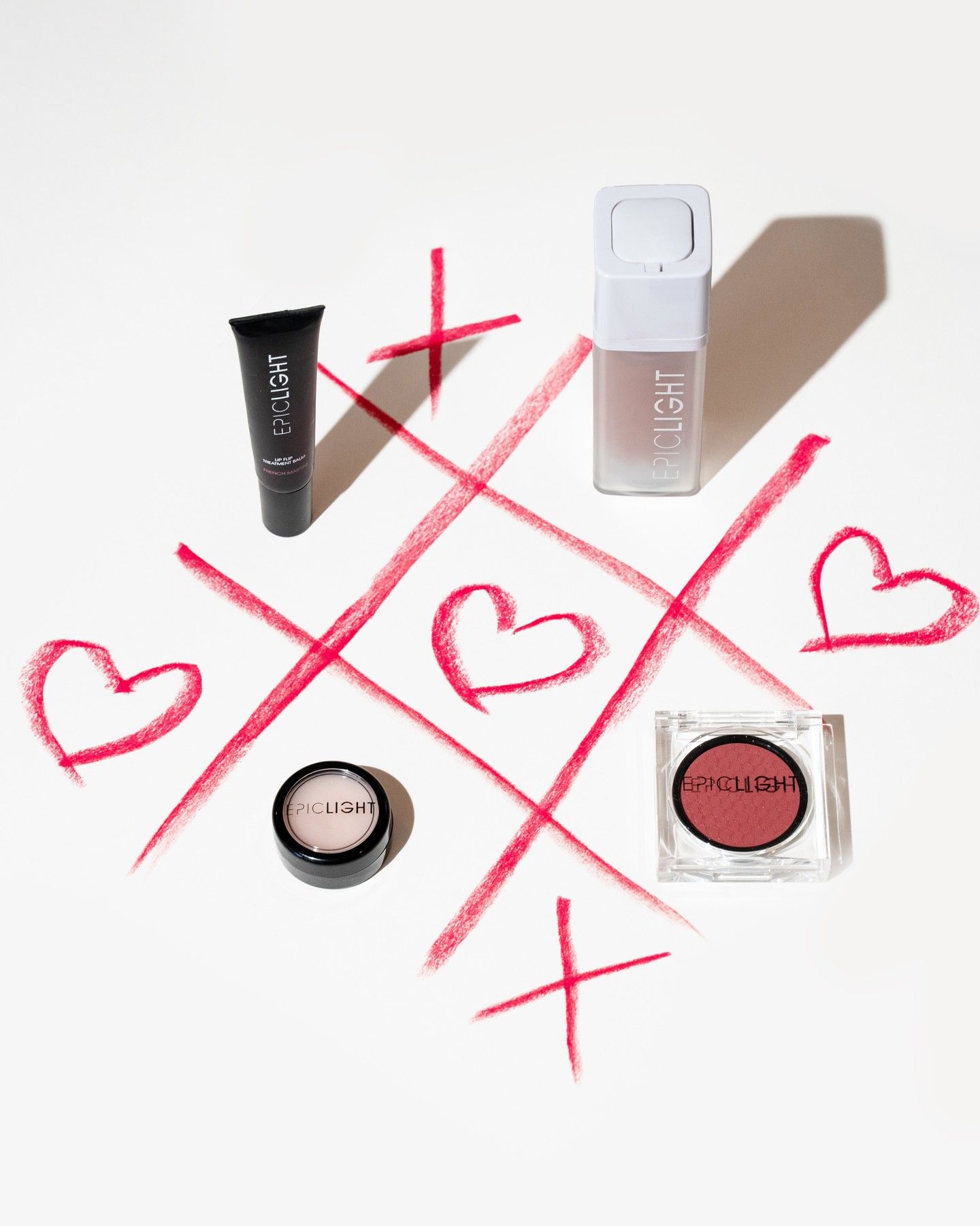 Makeup products on a lipstick-drawn tic-tac-toe grid