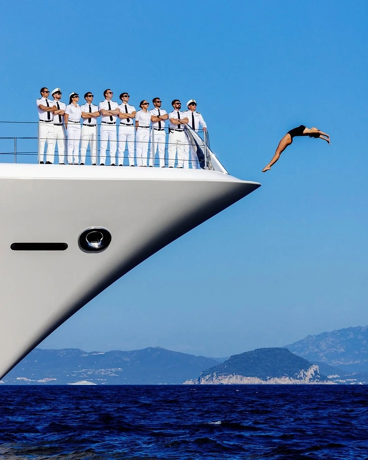 Cruises & Cruise Lines creative ad: Unexpected diver and yacht-bow composition