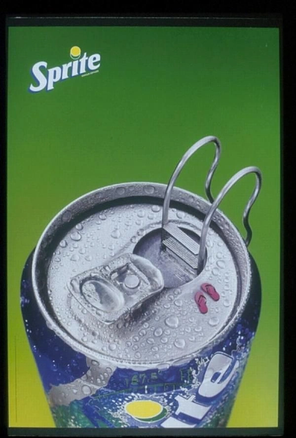 Creative ad: Chilled soda can top turned into a swimming pool with ladder and flip-flops