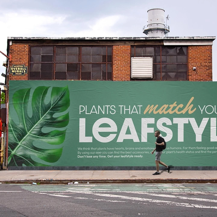 Plant Shops & Nurseries creative ad: Green billboard with a monstera leaf on a brick building