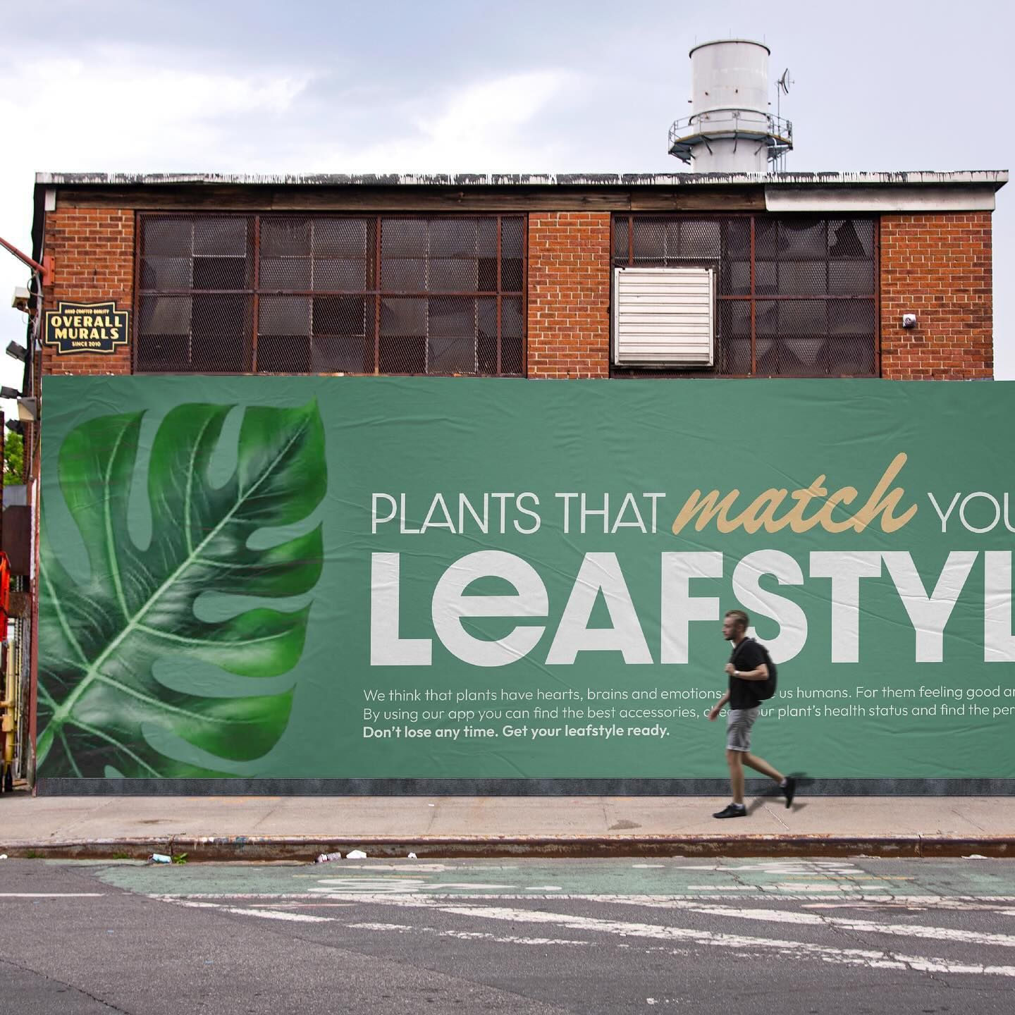 Banner: Green billboard with a monstera leaf on a brick building