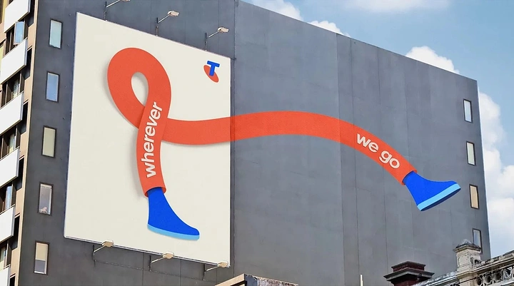 Telecom creative ad: Orange ribbon with blue shoes stepping out of a billboard