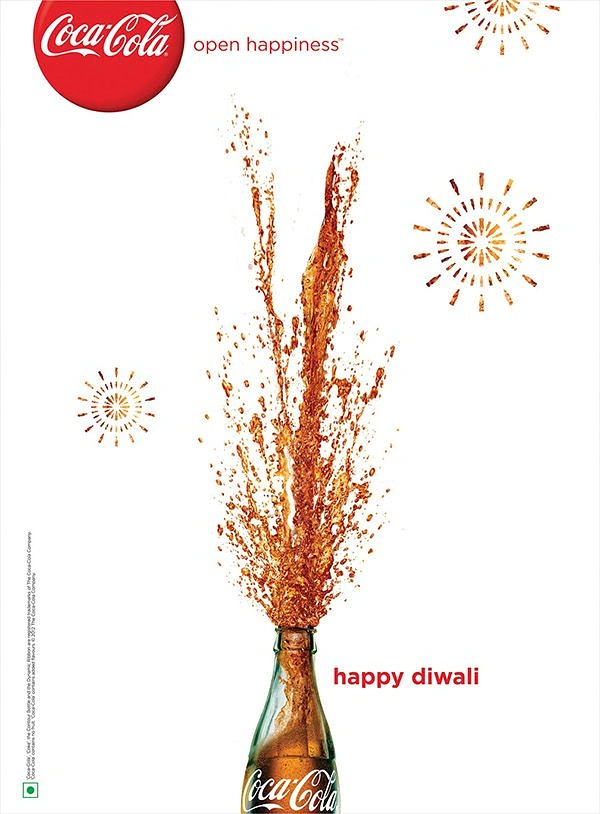 Diwali creative ad: Cola bursting from a glass bottle like a firework