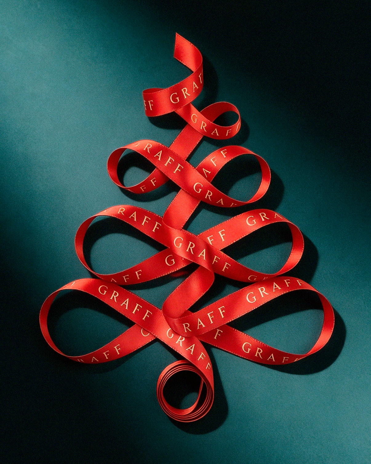 Branded red satin ribbon looped into a Christmas tree