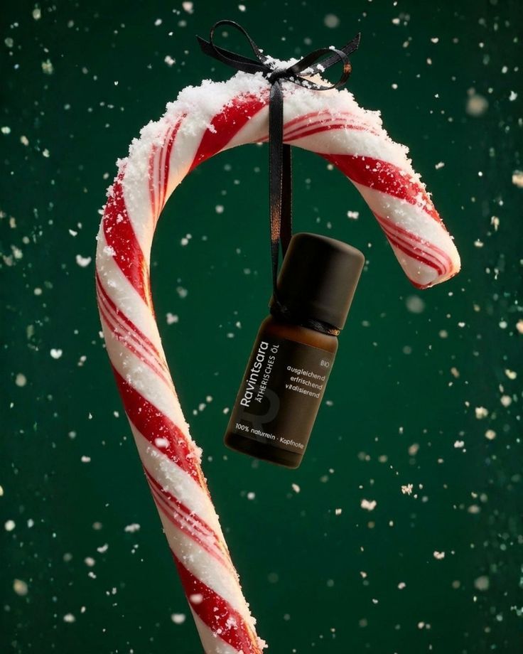 Christmas Instagram post: Essential oil bottle hanging from a snow-dusted candy cane
