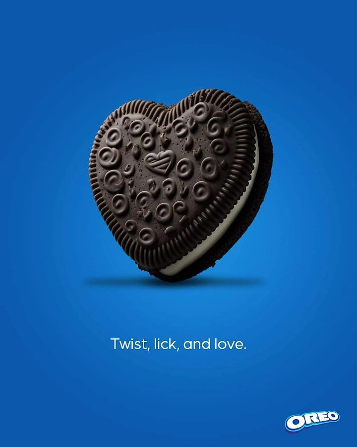 Valentine's Day creative ad: Heart-shaped chocolate sandwich cookie floating on blue