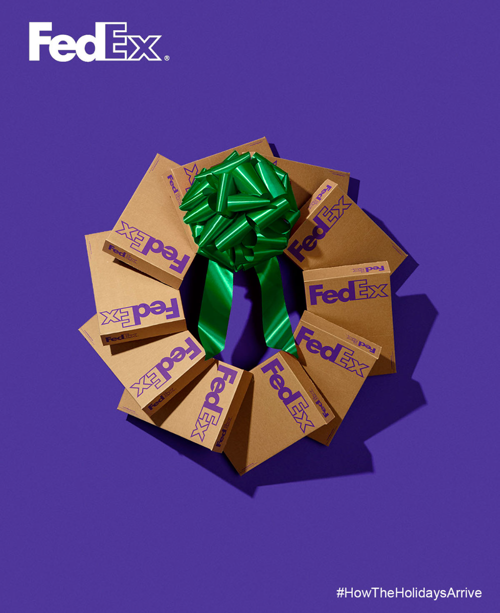 Christmas Instagram post: Wreath made of branded cardboard shipping boxes topped with a green bow