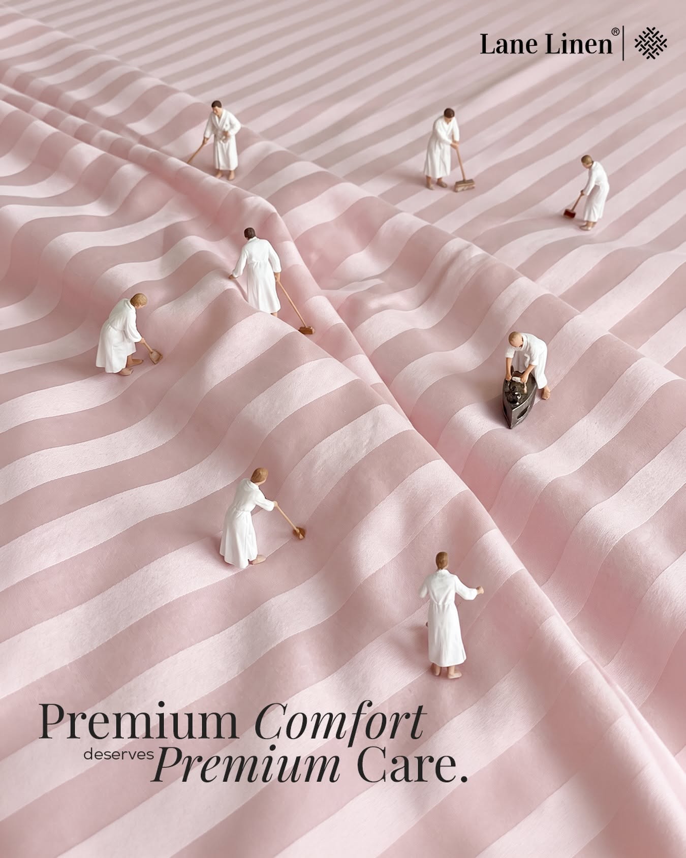 Instagram post: Miniature attendants cleaning and ironing a pink striped bedsheet