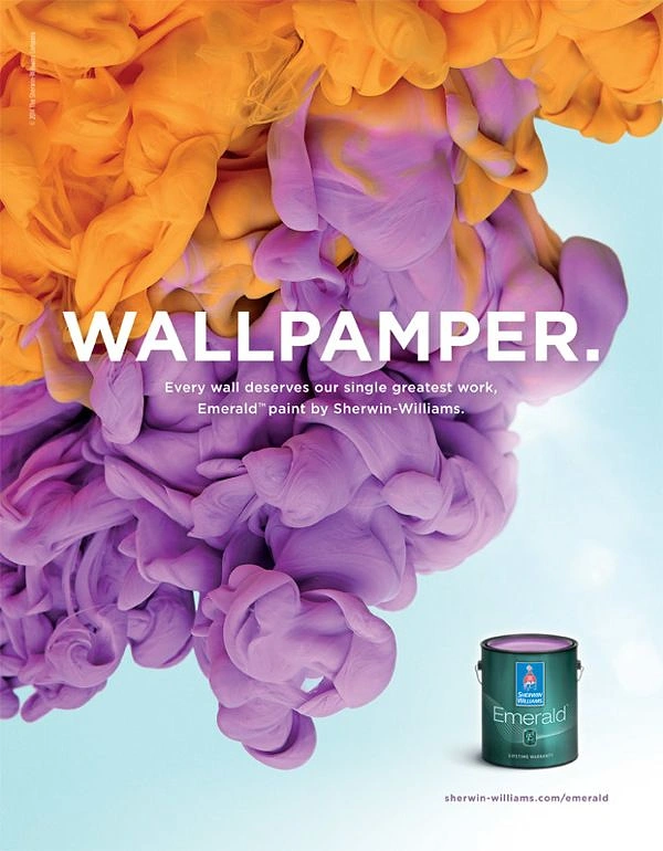 Construction creative ad: Orange and violet paint clouds cascading across a pale blue background