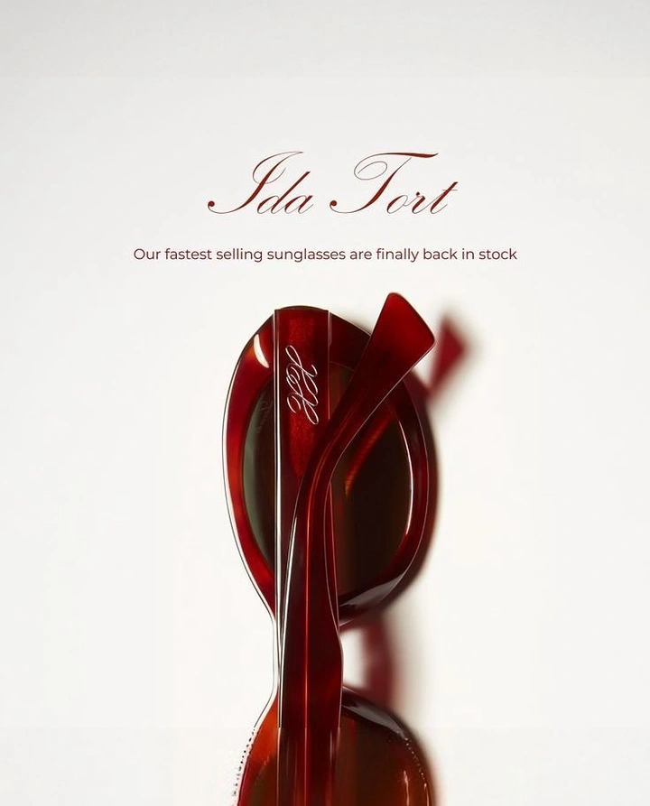 Creative ad: Folded red tortoiseshell sunglasses standing upright