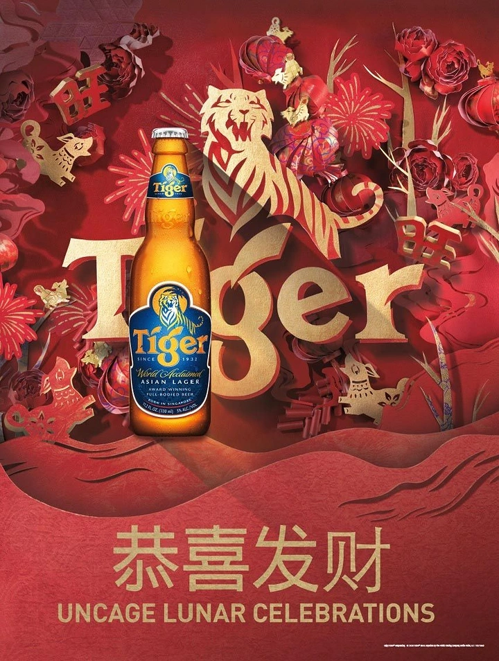 Lunar New Year creative ad: Beer bottle in front of a layered paper-cut tiger and giant gold wordmark