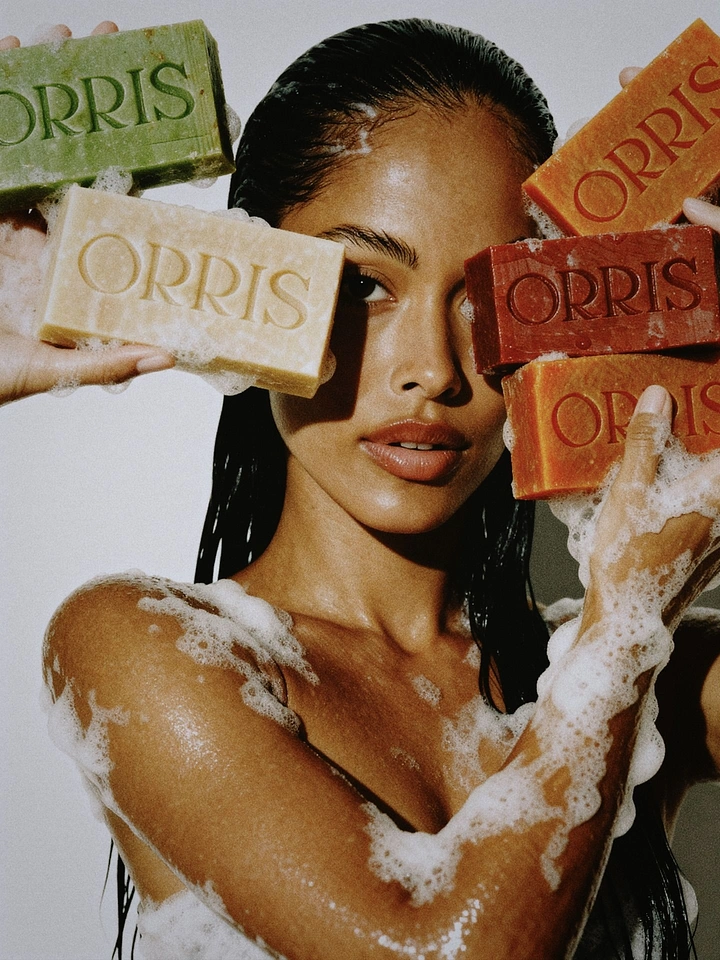 Beauty & Salon creative ad: Wet-haired model holding colourful embossed soap bars up to her face