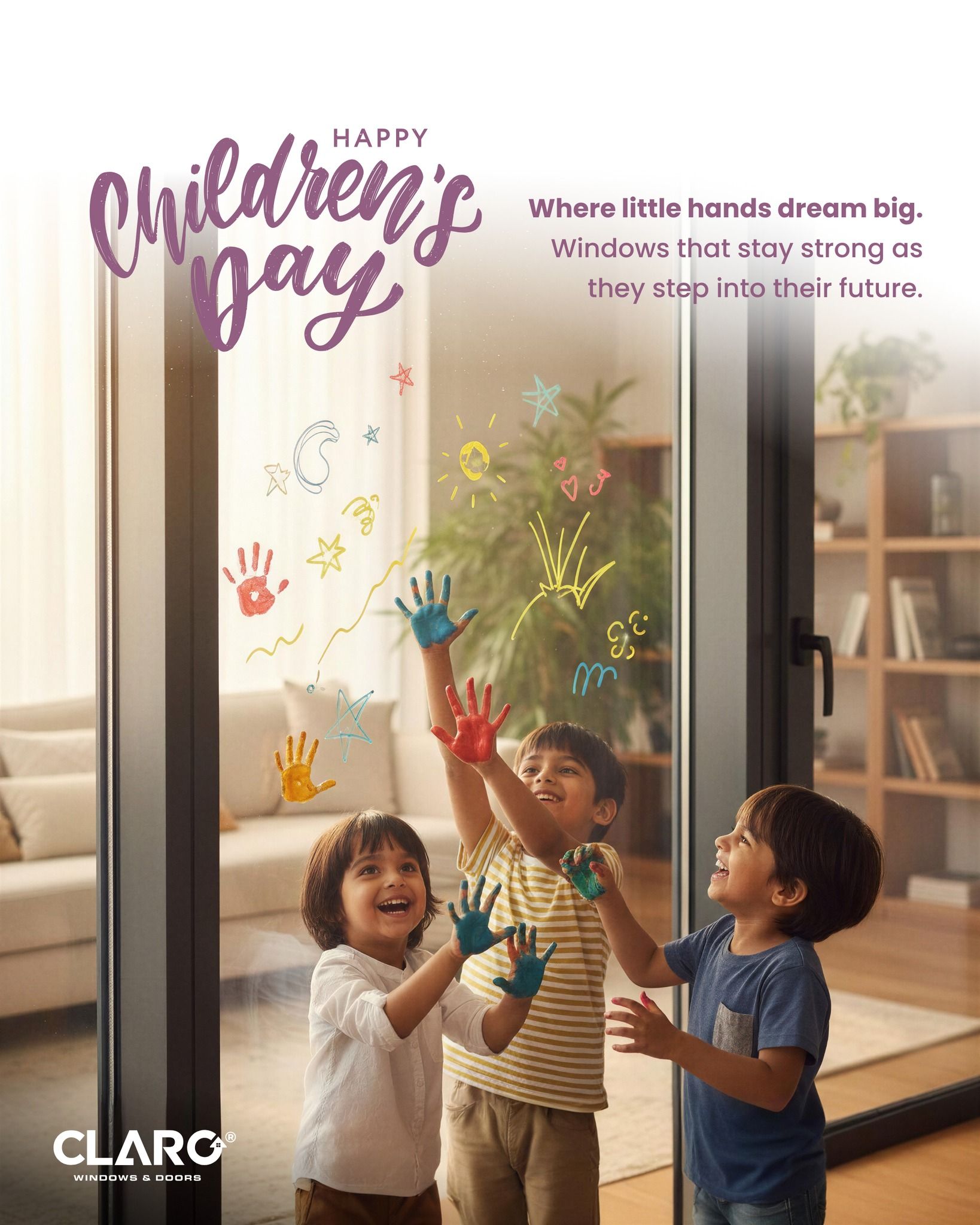 Three laughing children pressing painted hands on a glass sliding door