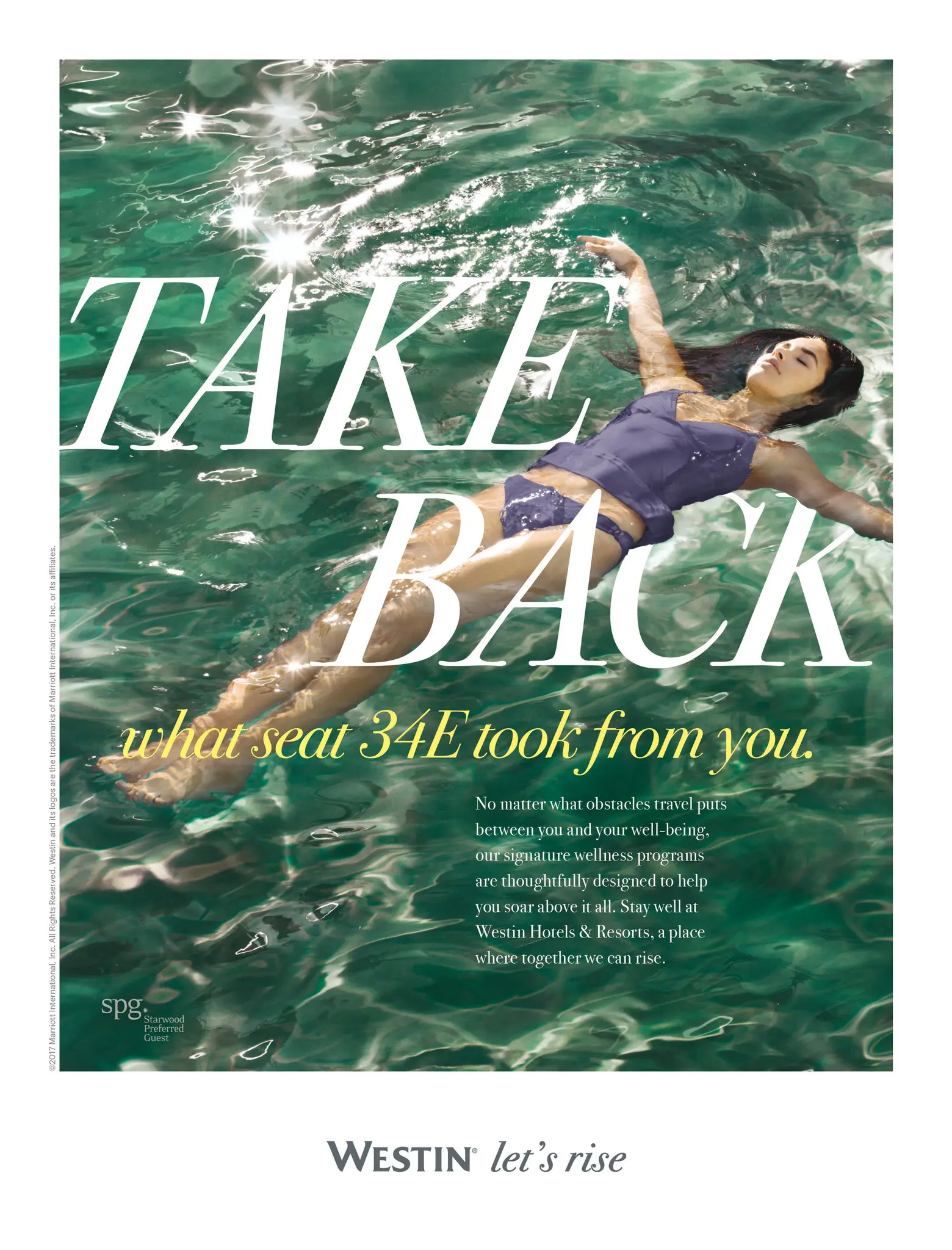 Woman floating on her back in sparkling green water