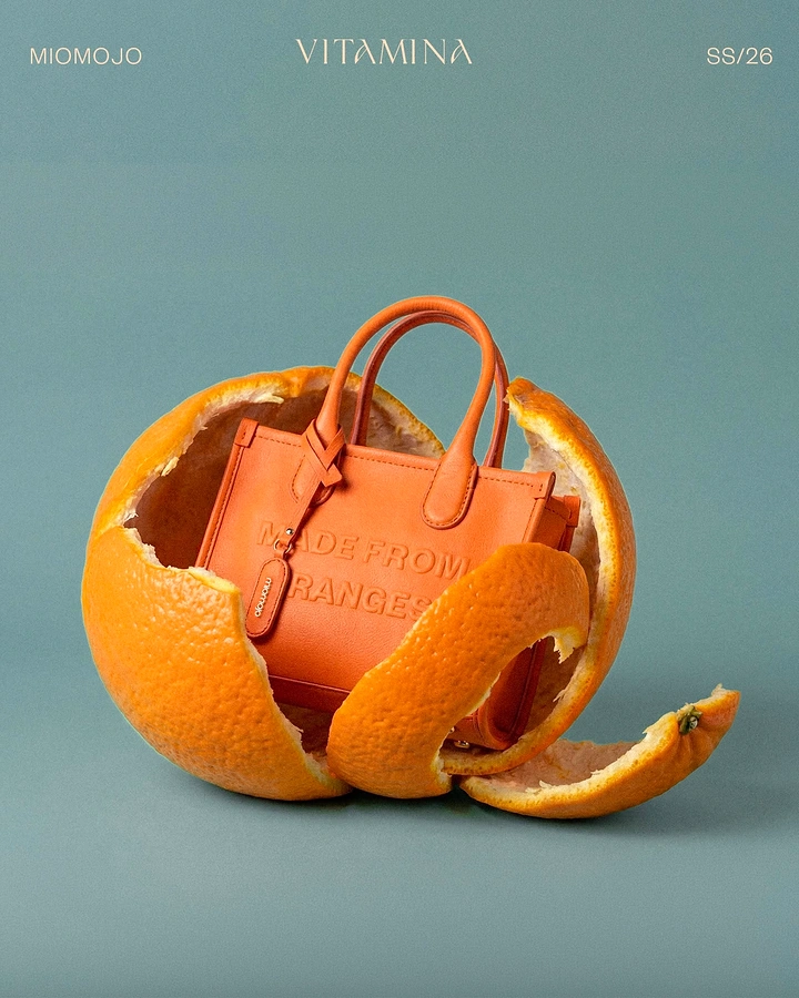 Creative ad: Orange mini tote nestled inside a peeled orange shell