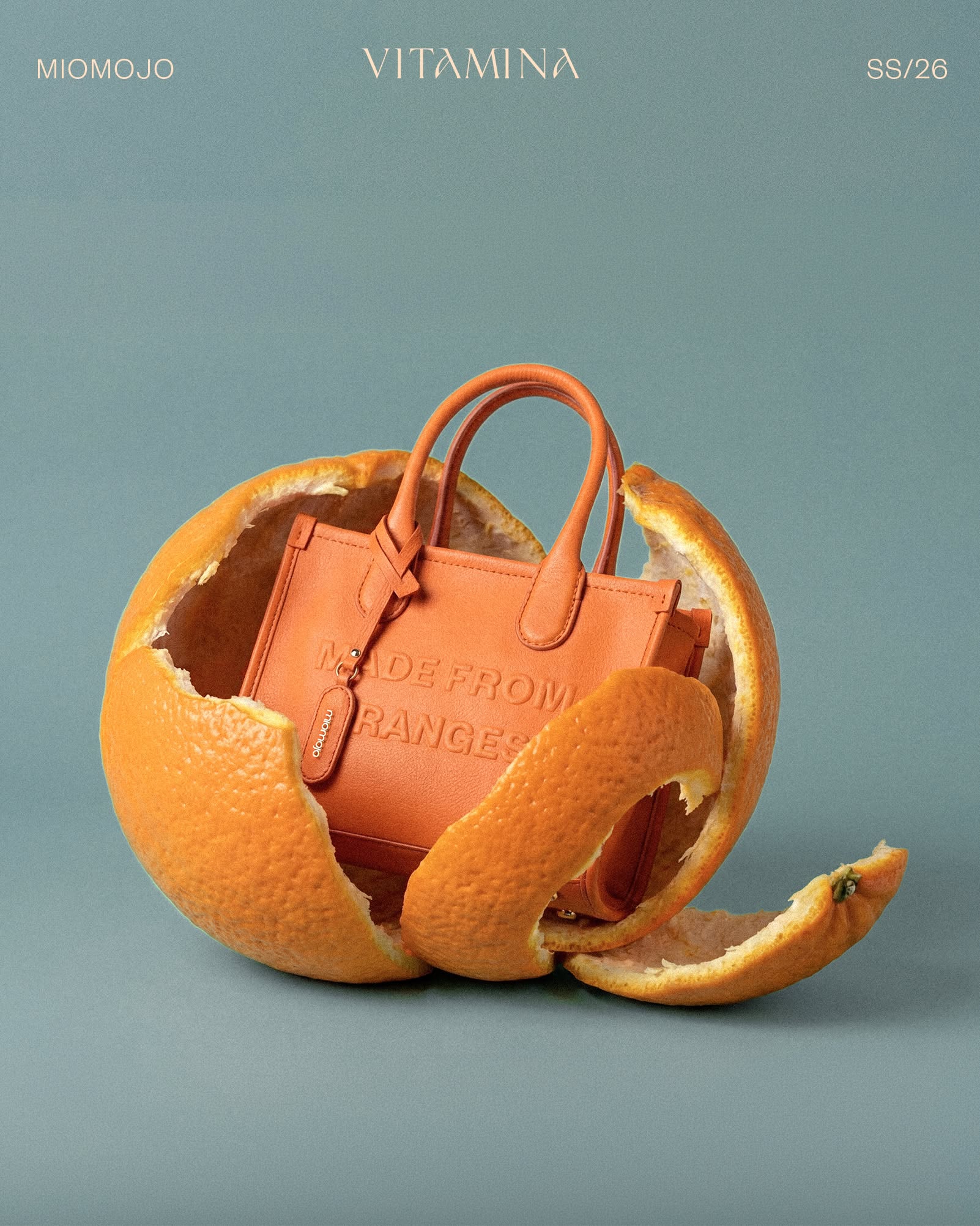 Instagram post: Orange mini tote nestled inside a peeled orange shell