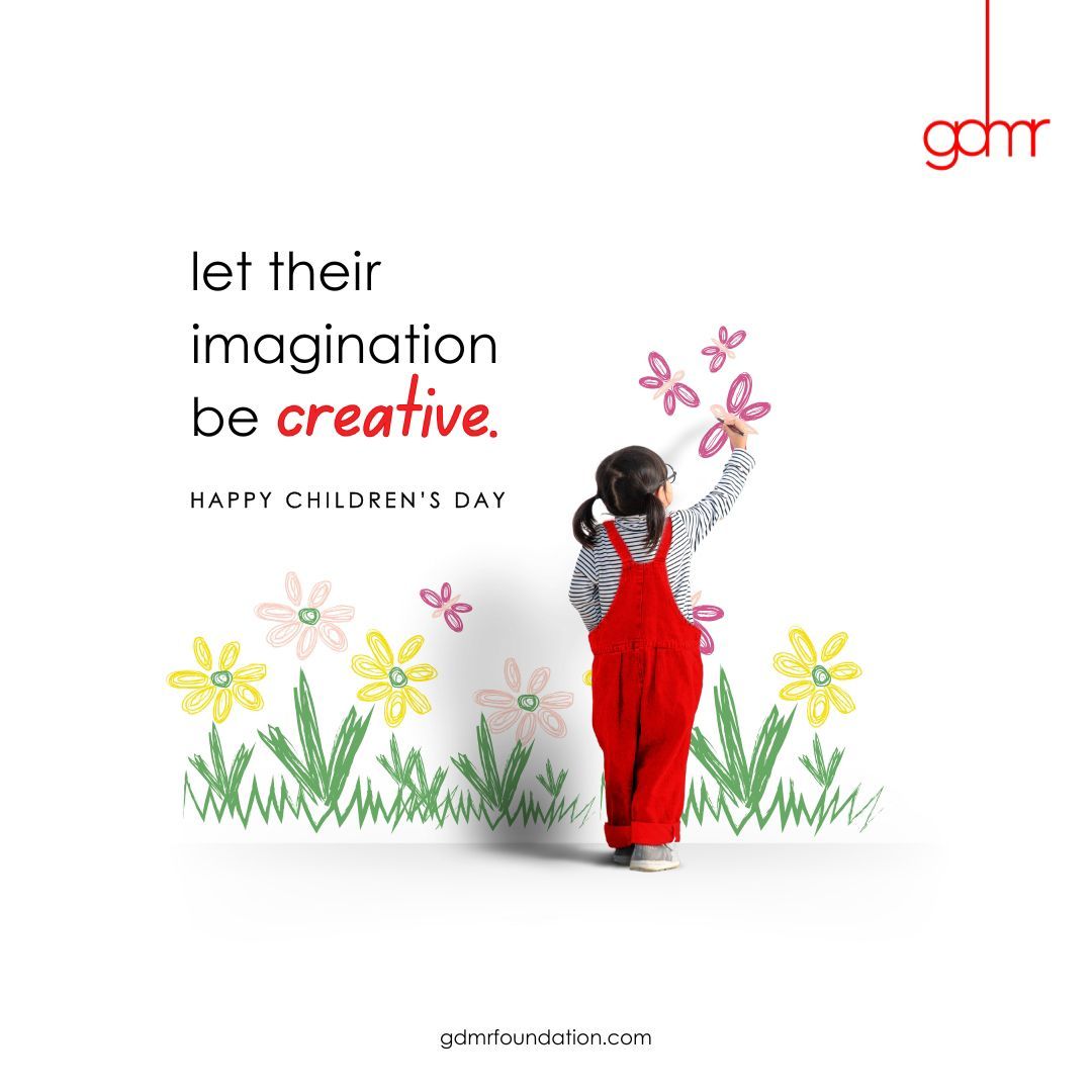 Girl in red dungarees drawing flowers and butterflies on a white wall