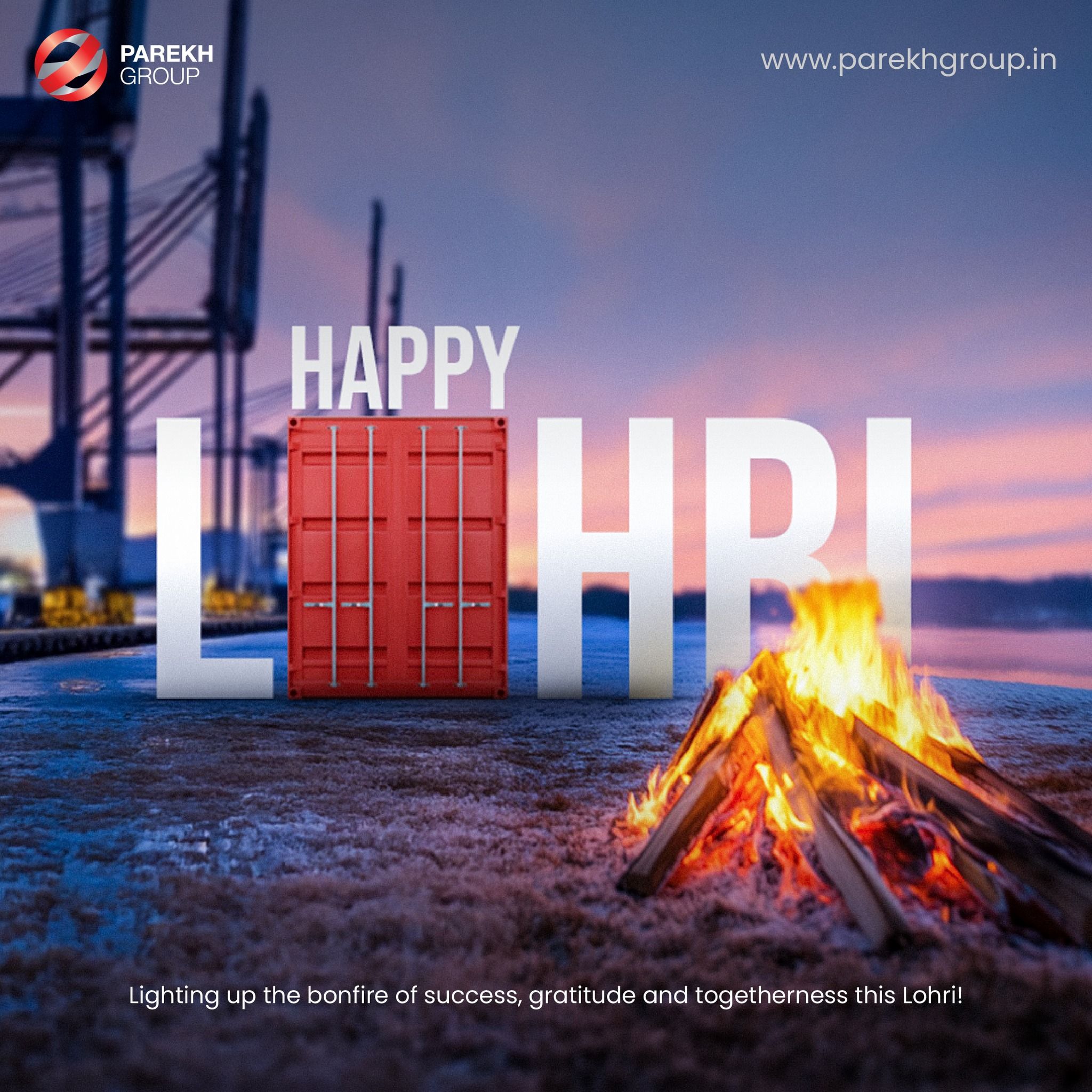 Giant LOHRI letters with a red shipping container as the O, beside a bonfire