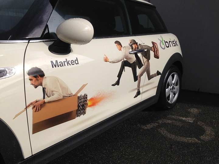 Window Tinting & Car Wraps creative ad: People appear to climb across van