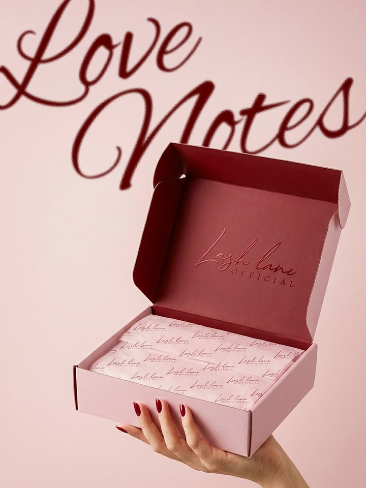 Valentine's Day creative ad: Hand holding open pink branded gift box