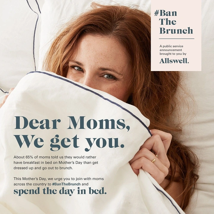 Mother's Day creative ad: Red-haired woman peeking over a white duvet in bed
