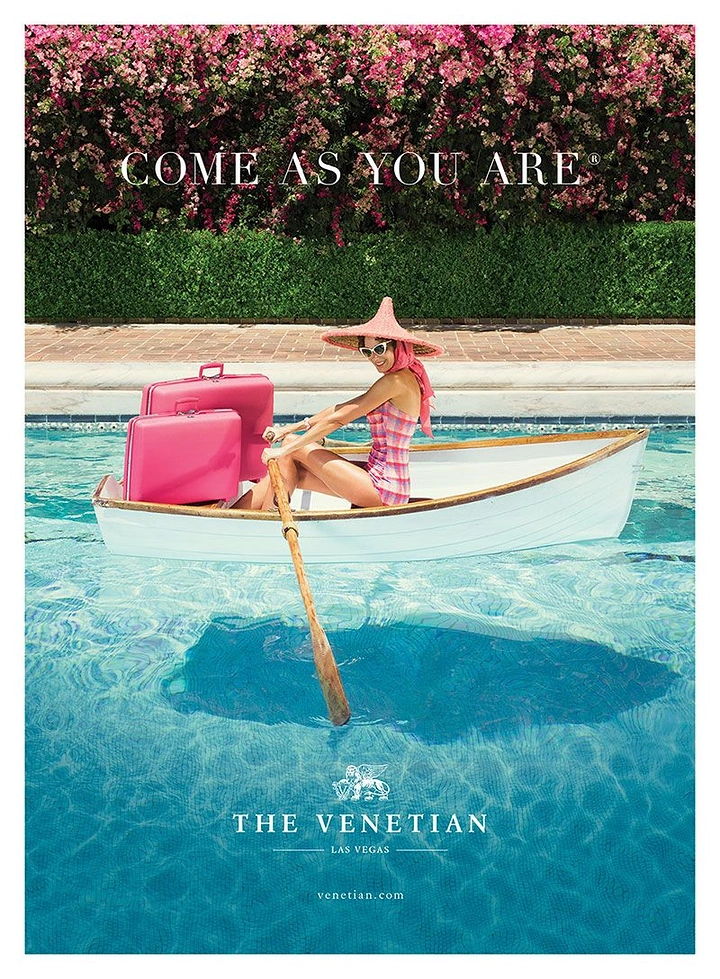 Creative ad: Retro-styled woman rowing a boat with pink luggage across a pool