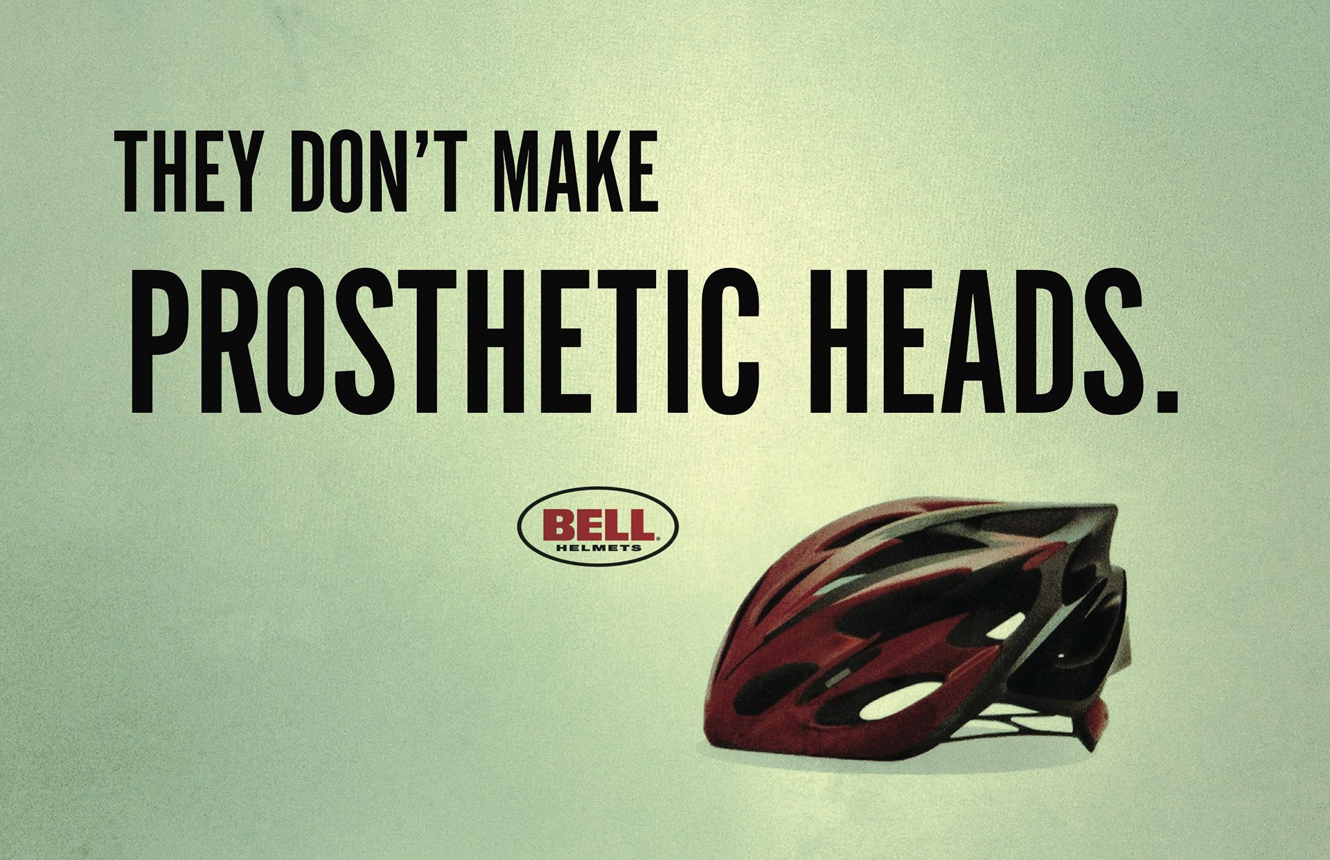 Banner: Red and black bicycle helmet on a pale green ground