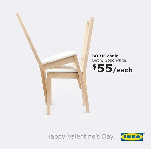 Valentine's Day creative ad: Two birch dining chairs leaning into each other like an embracing couple