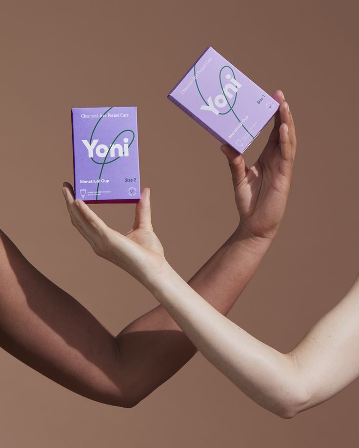 Instagram post: Two crossed arms of different skin tones holding lavender menstrual cup boxes