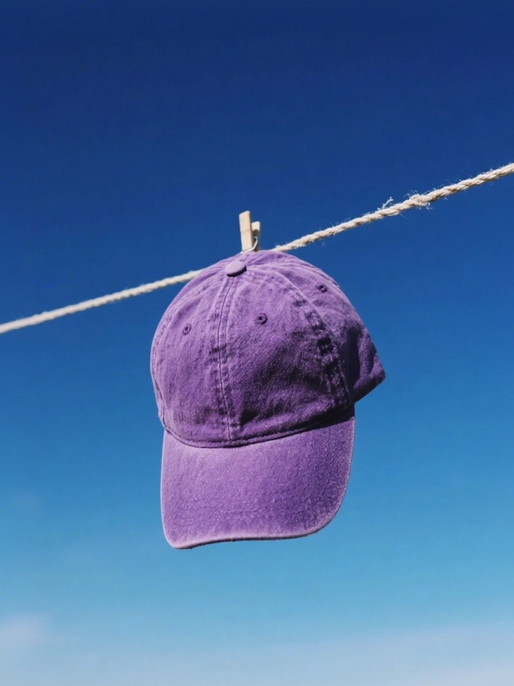 Hats & Caps creative ad: Cap suspended in unexpected setting