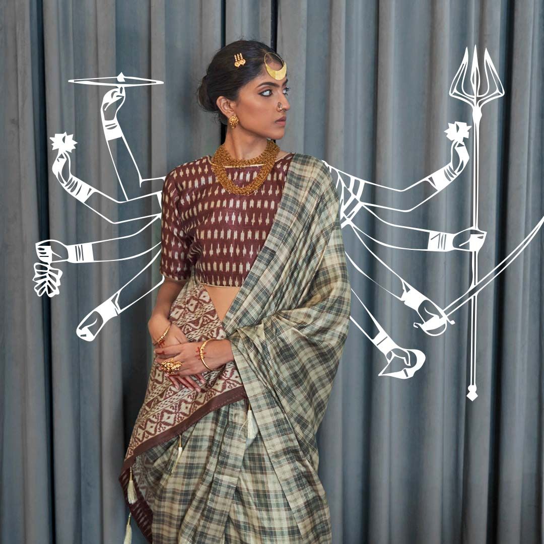 Woman in handloom saree with white line-drawn Durga arms