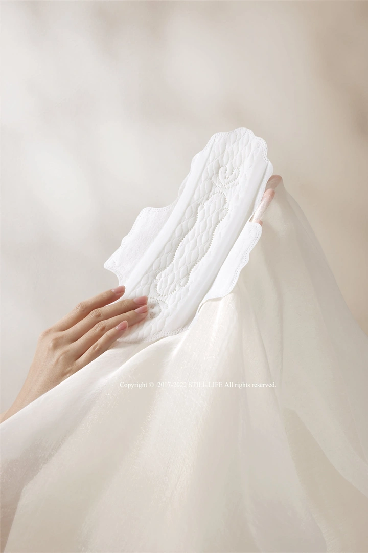 Period Care & Feminine Hygiene creative ad: Pad integrated into flowing white fabric