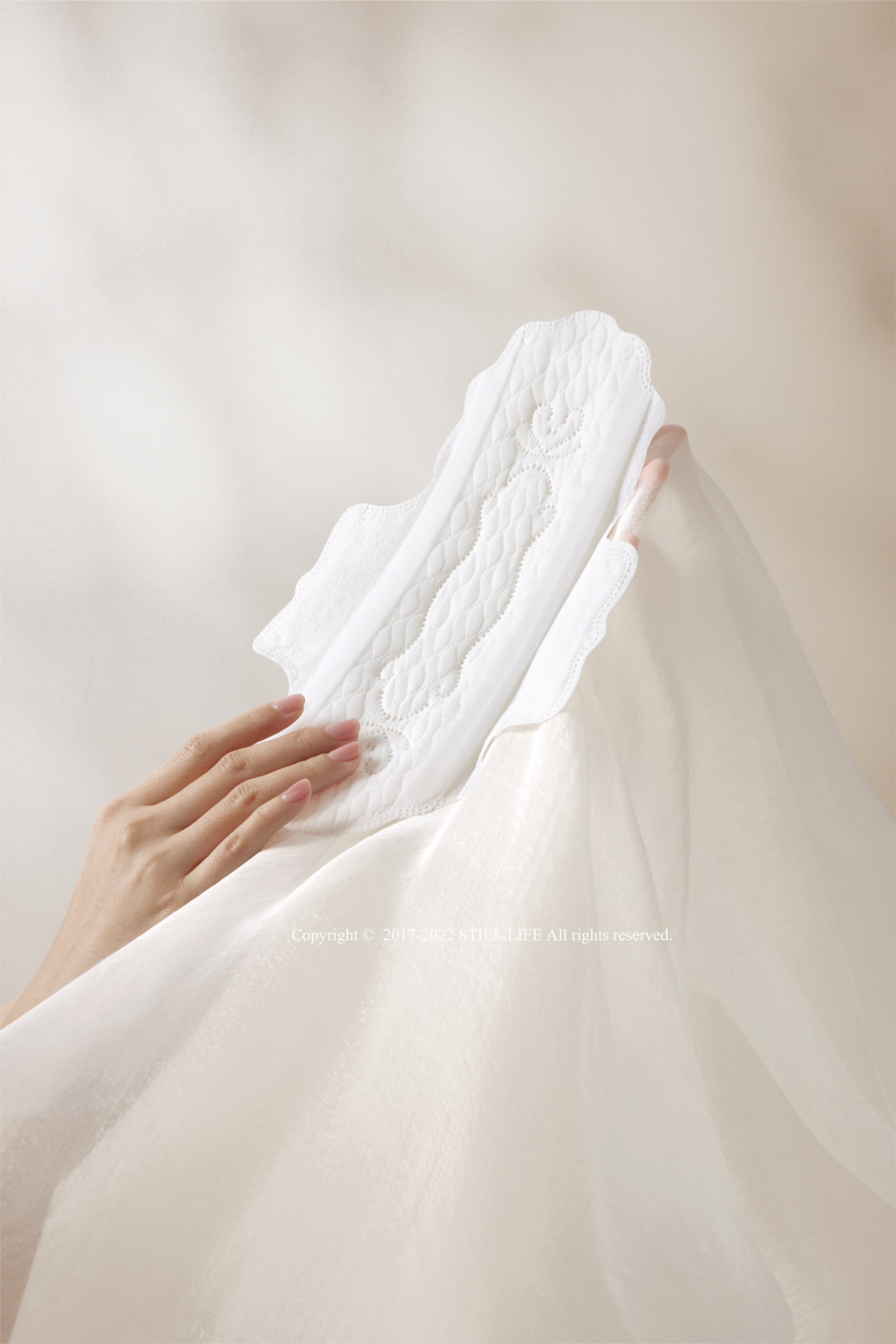 Story: Pad integrated into flowing white fabric