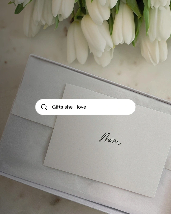 Mother's Day creative ad: Top-down gift box with a handwritten card beside white tulips