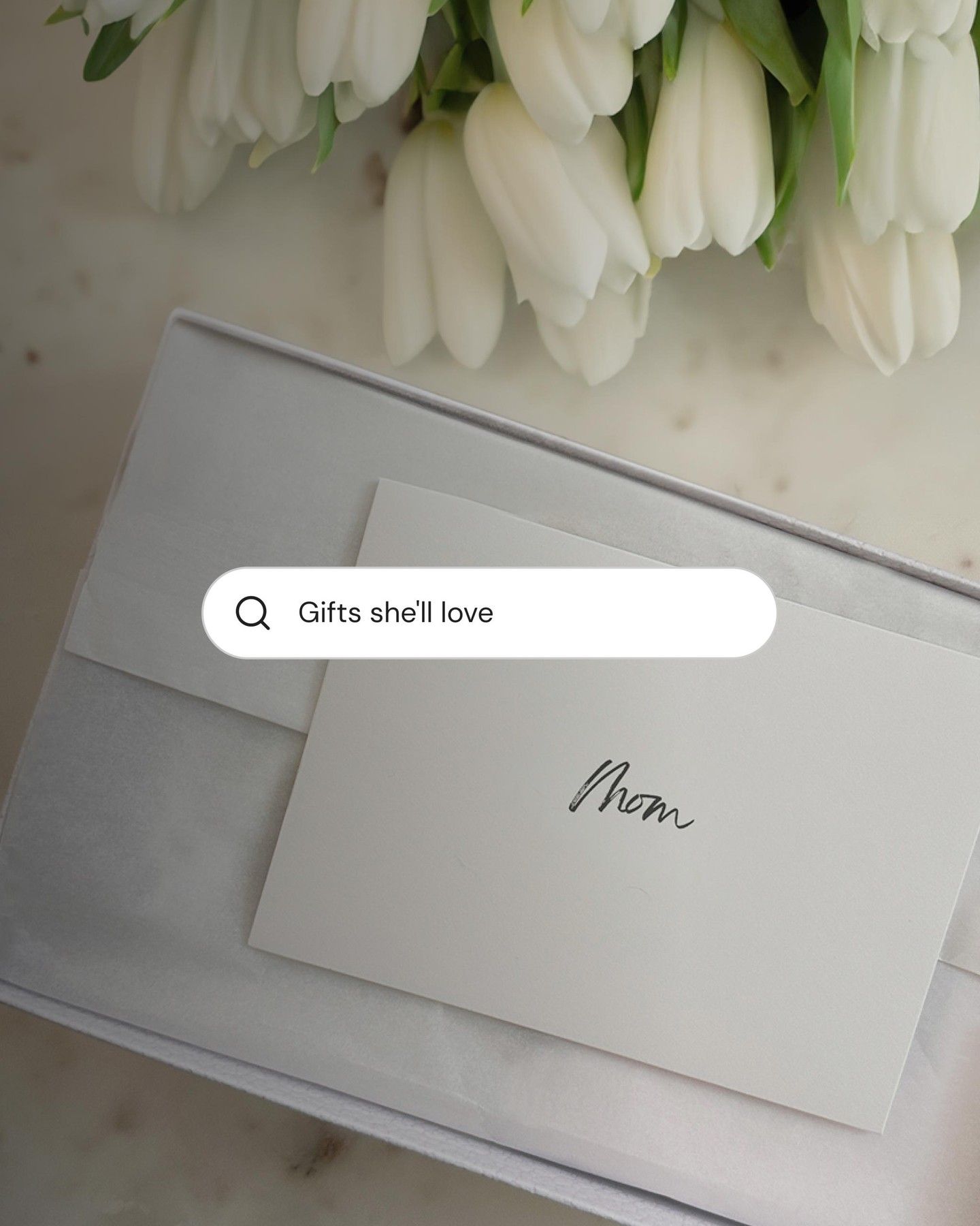 Mother's Day Instagram post: Top-down gift box with a handwritten card beside white tulips
